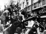 Gente festejando sobre un carro de combate en Lisboa durante la Revolución de los Claveles.
