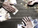 3 generations of hands with euro coins and notes on table