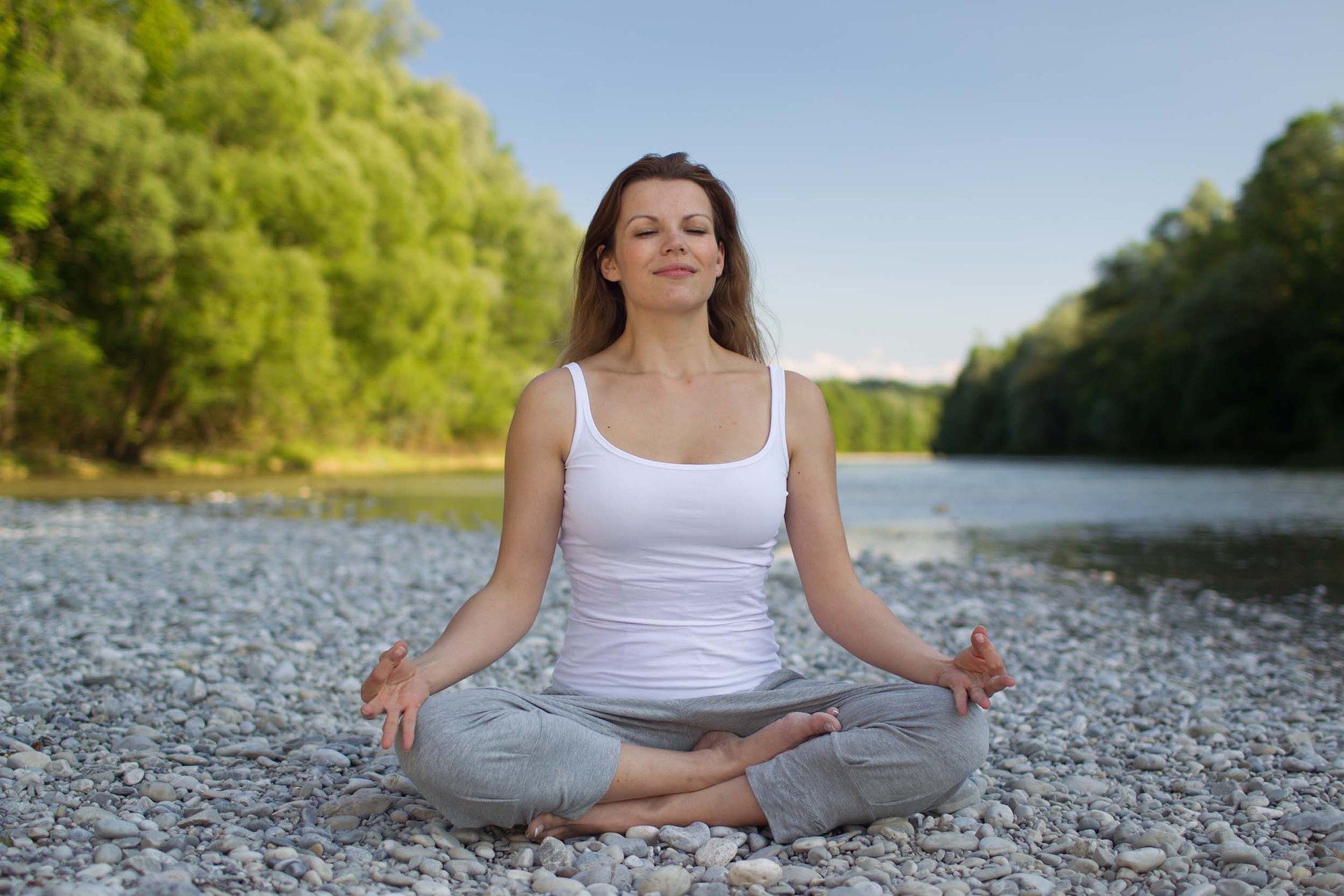 A woman practices meditation outdoors
