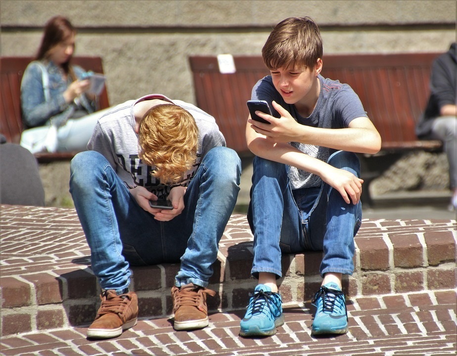 Teenagers with cell phones.
