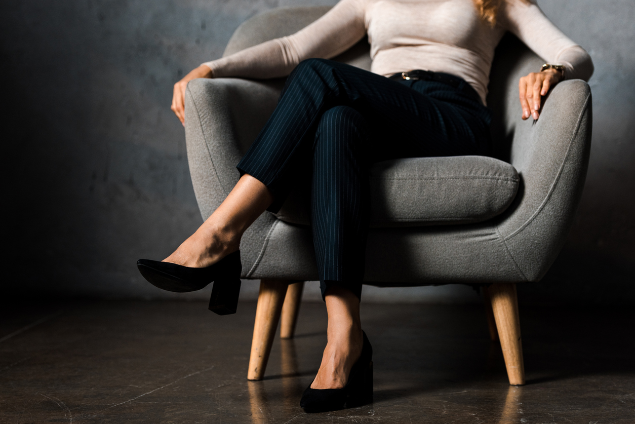 Woman sitting cross-legged.