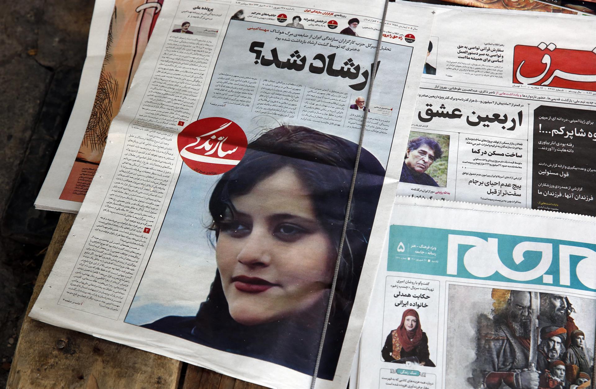 Iranian newspaper with a picture of Mahsa Amini, a young woman who died in police custody after being arrested for wrongly wearing the Islamic veil.
