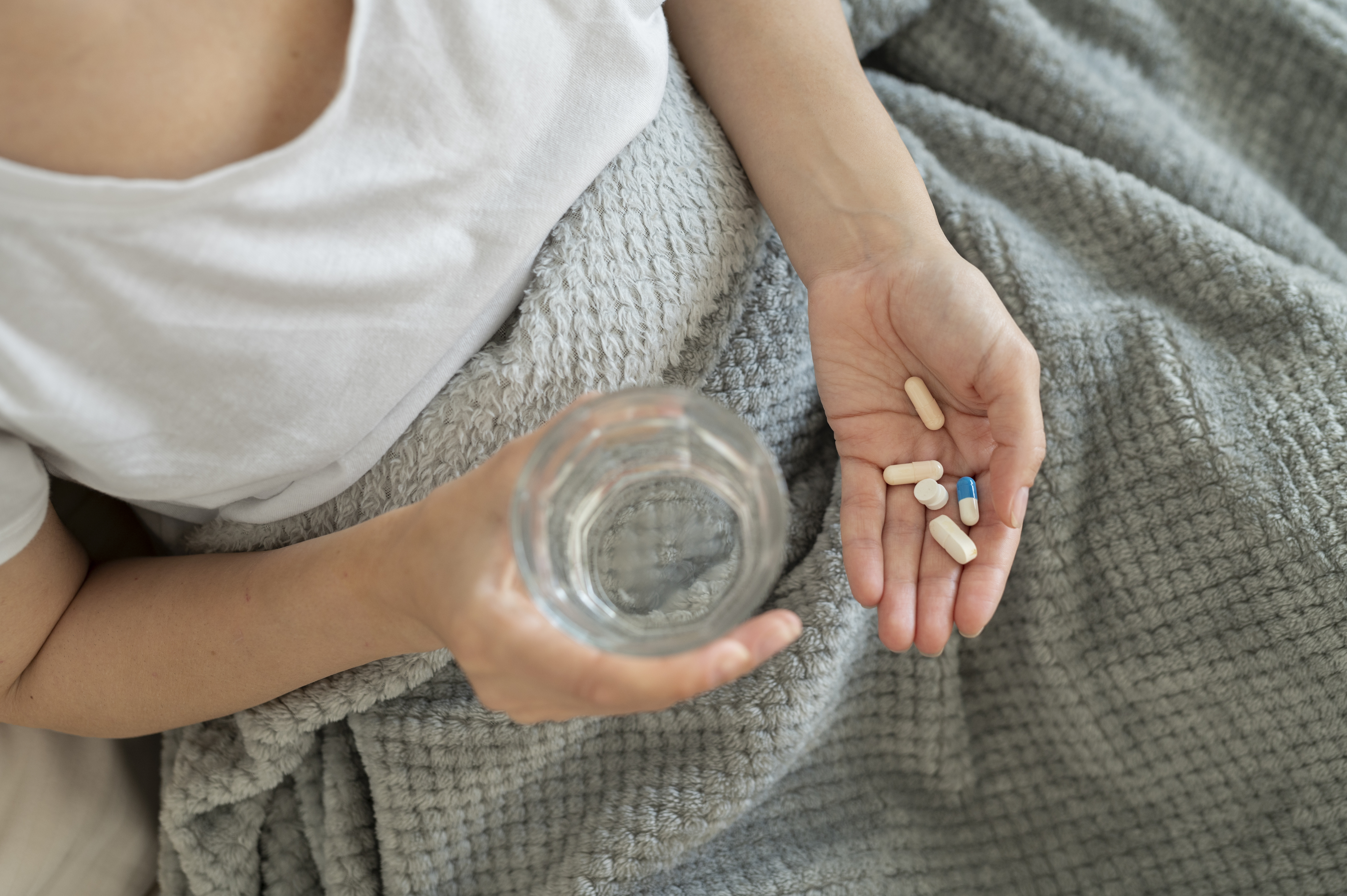 A person taking various medications, in a file image.