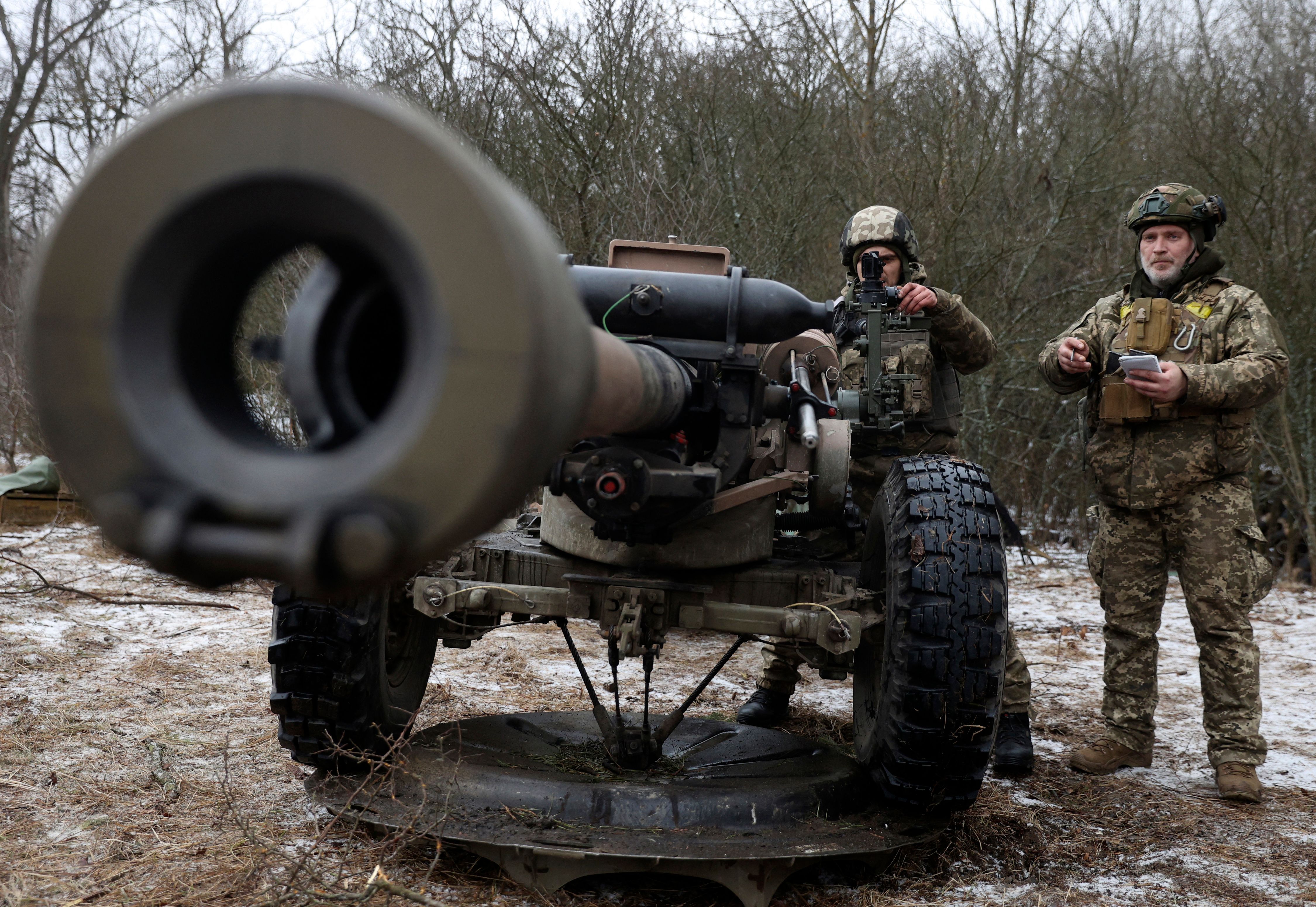 Ukrainian servicemen prepare to fire an L119 howitzer at Russian frontline positions in the Luhansk region last January.
