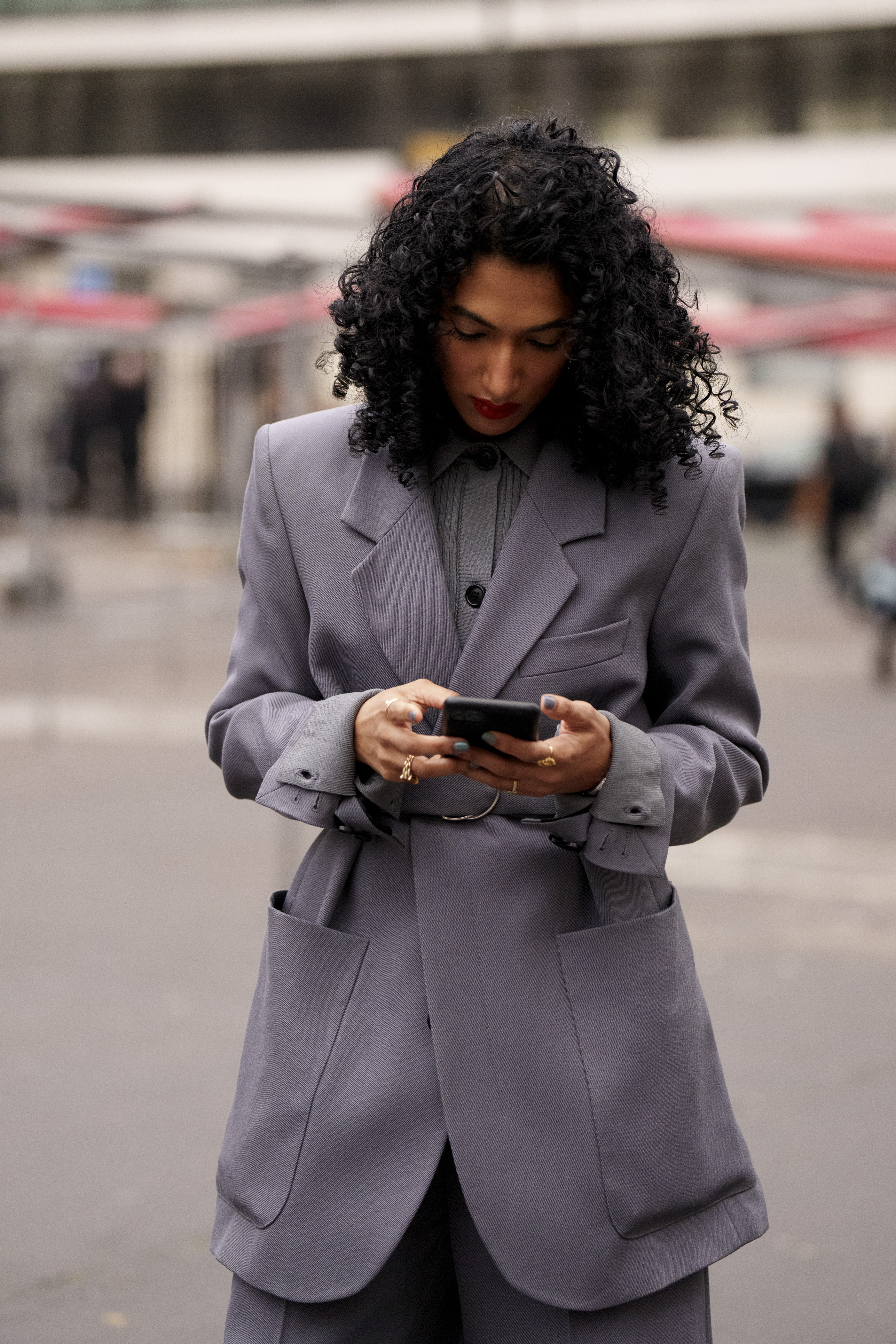 An insider with an 'oversize' blazer with a belt in the 'street-style'.