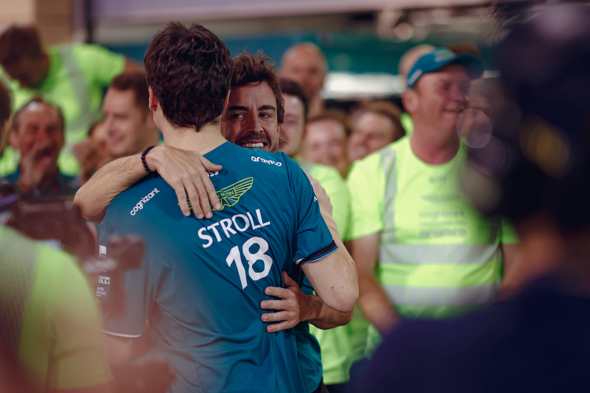 Lance Stroll and Fernando Alonso embrace after the Spaniard's podium in Bahrain.