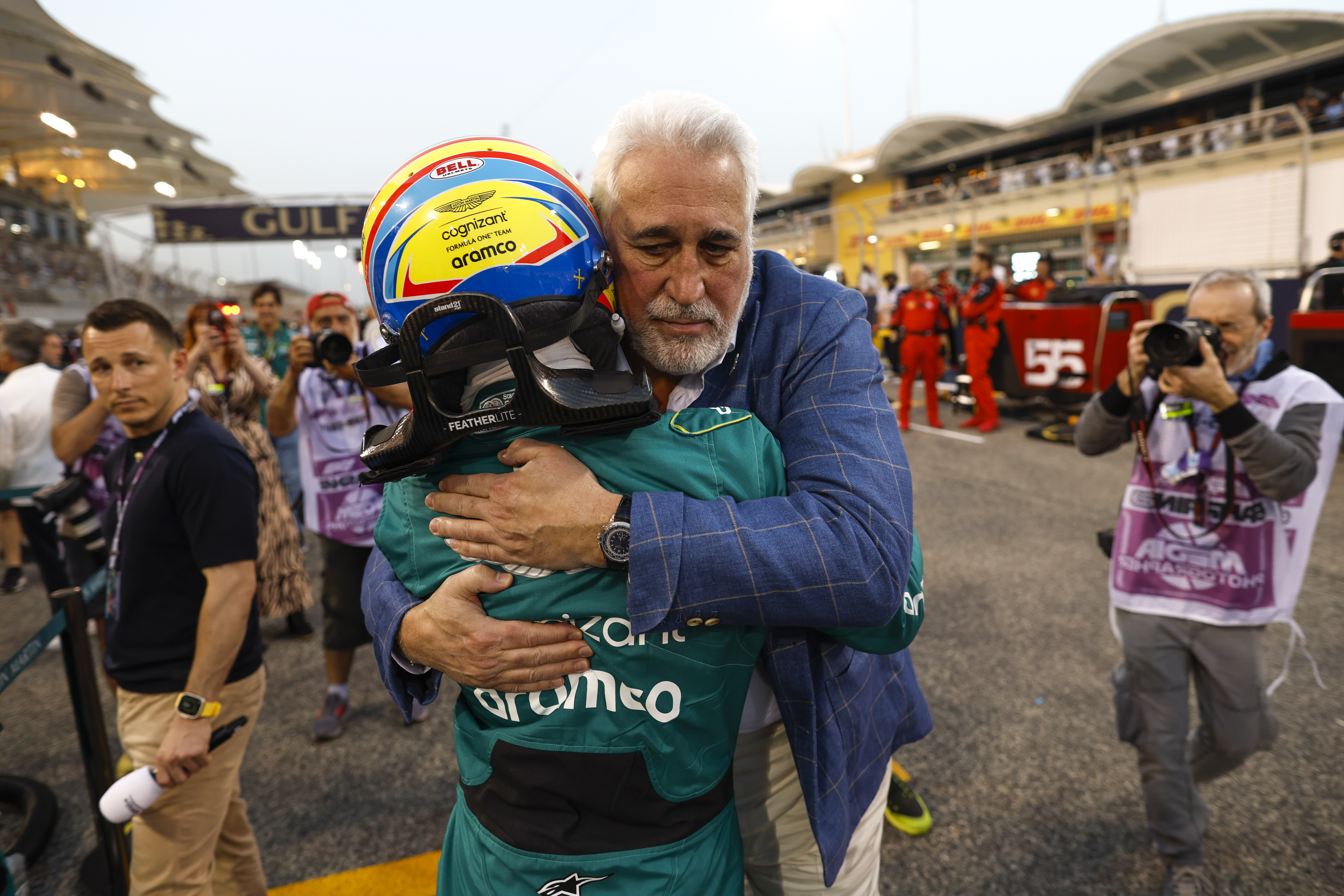 Lawrence Stroll hugs Fernando Alonso effusively after finishing the Bahrain GP.