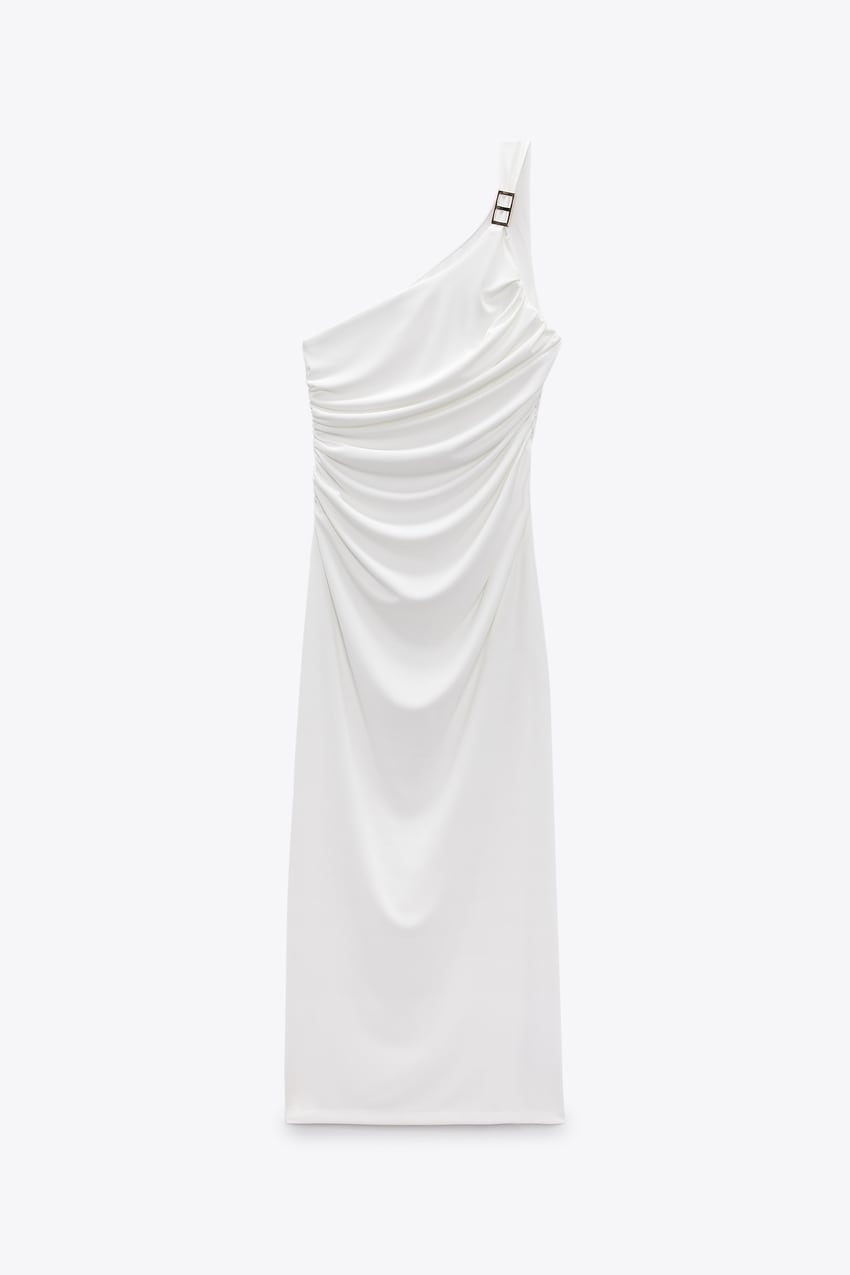 White dress with an asymmetric neckline and draping.