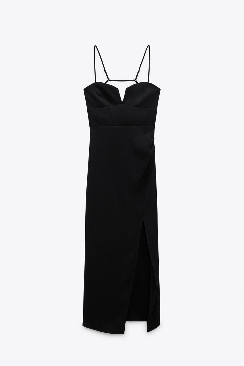 Black midi length dress with pleat detail.